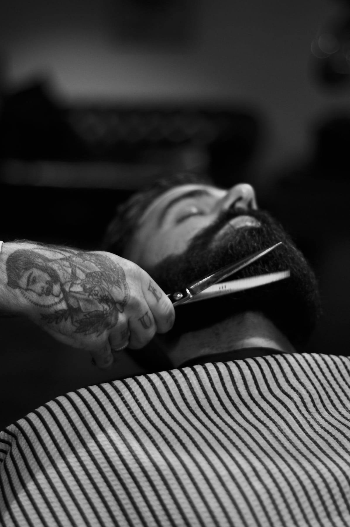 Black-and-white photo of beard trimming with scissors