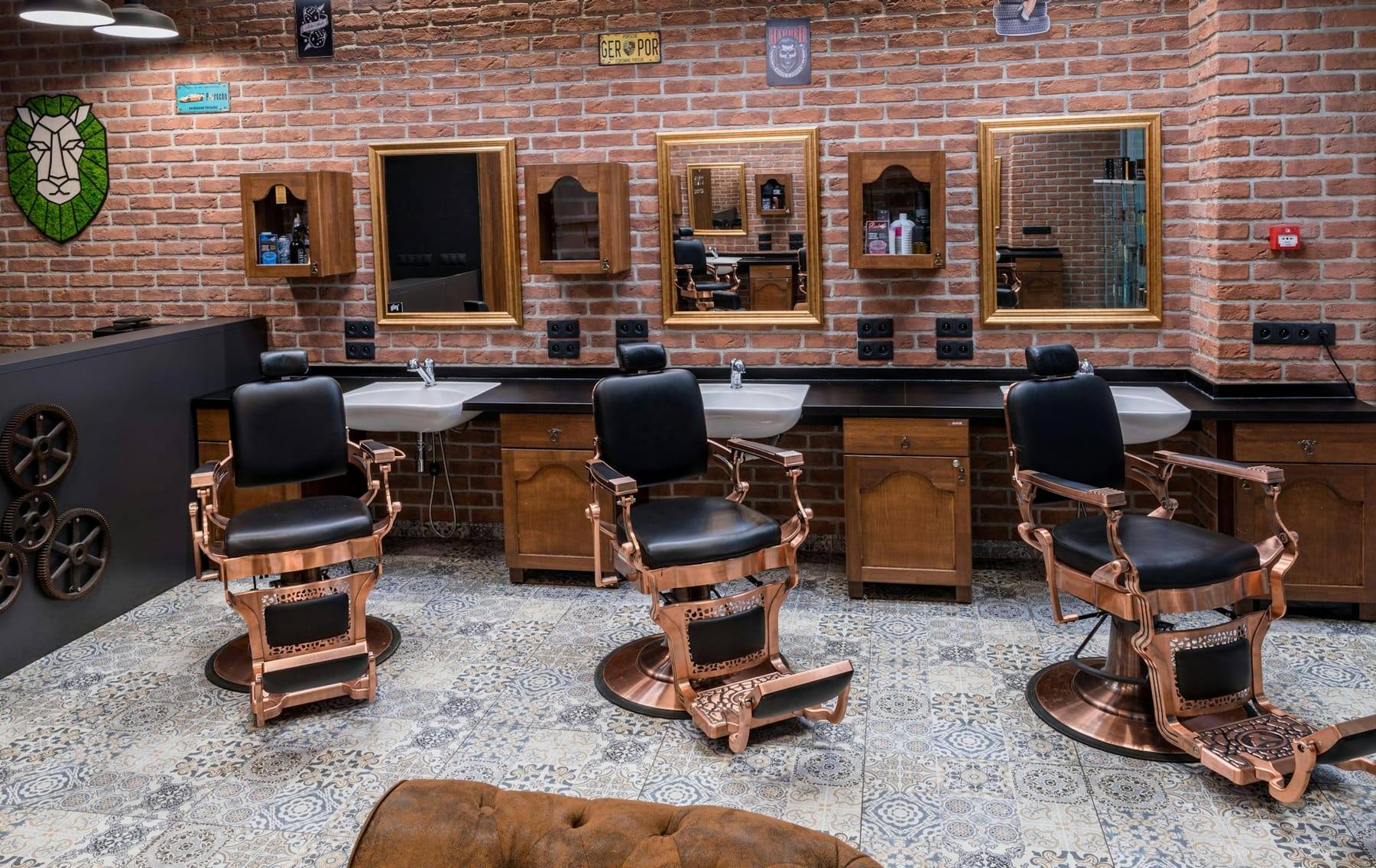 Row of barber chairs against brick